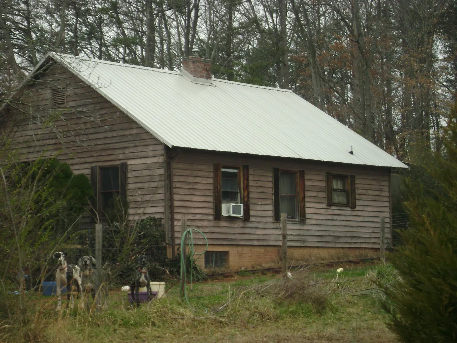White metal roof on an old wood sided farmhouse, from a Metal Roof Installation job in Aydlett